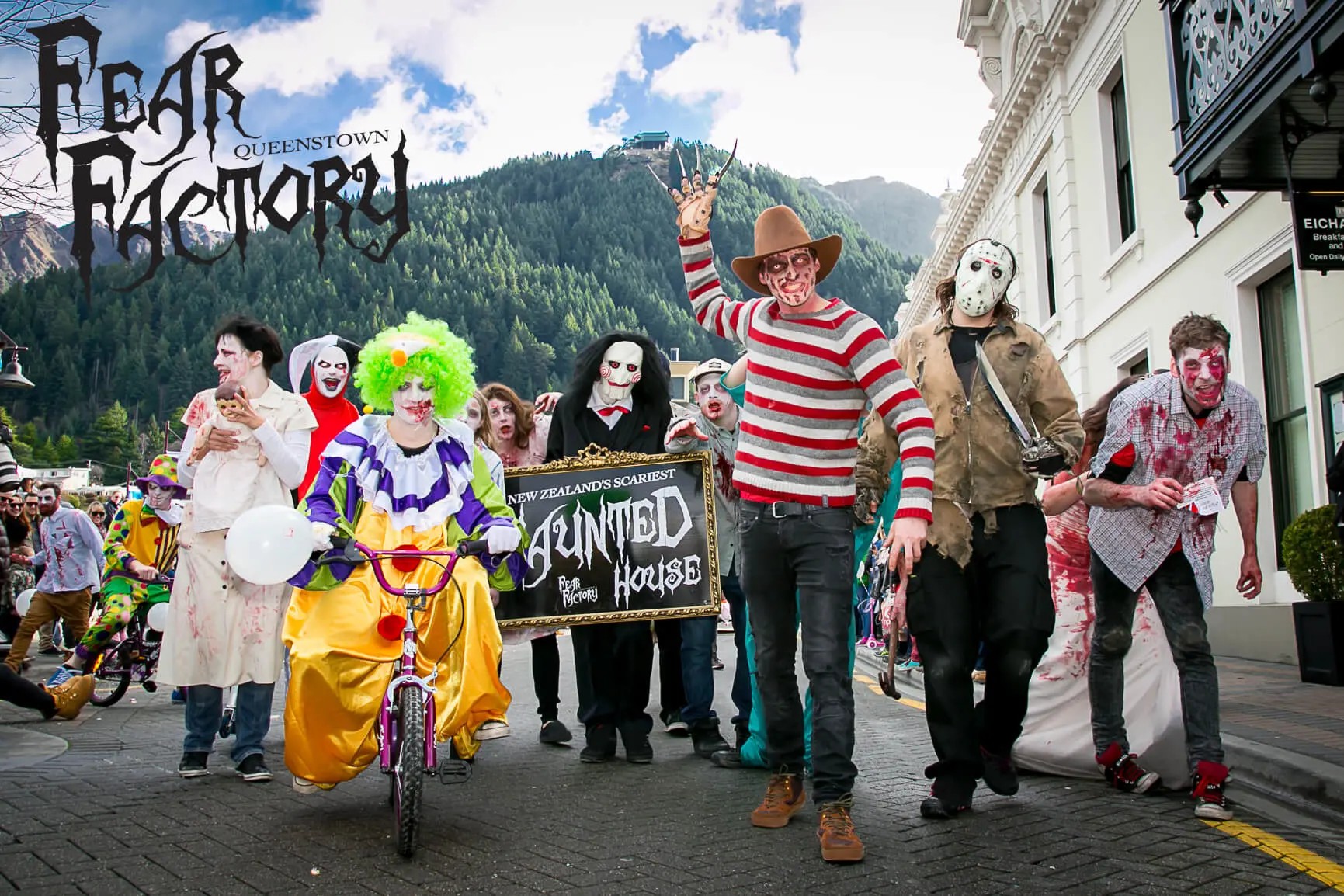 Group of performers dressed in scary Halloween costumes on the street.