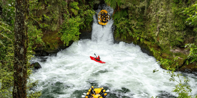 A Kaituna Cascades rafting trip navigates an impressive waterfall on the Kaituna River in Rotorua.