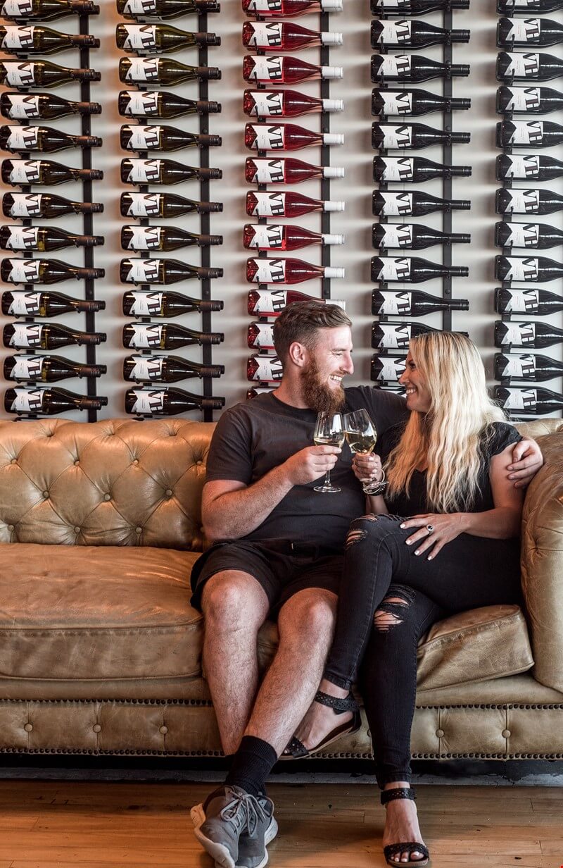 A couple enjoying a glass of wine at the Volcanic Hills tasting room.