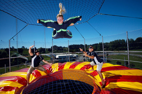 Girl enjoying an indoor skydiving experience thats outside at Velocity Valley in Rotorua.