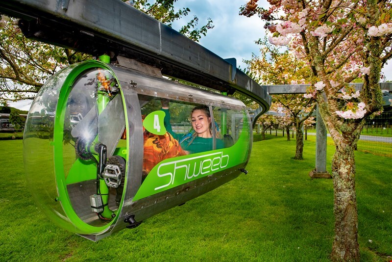 People riding the Sweeb (a sort of pedal powerd mono-rail) at Velocity Valley in Rotorua.