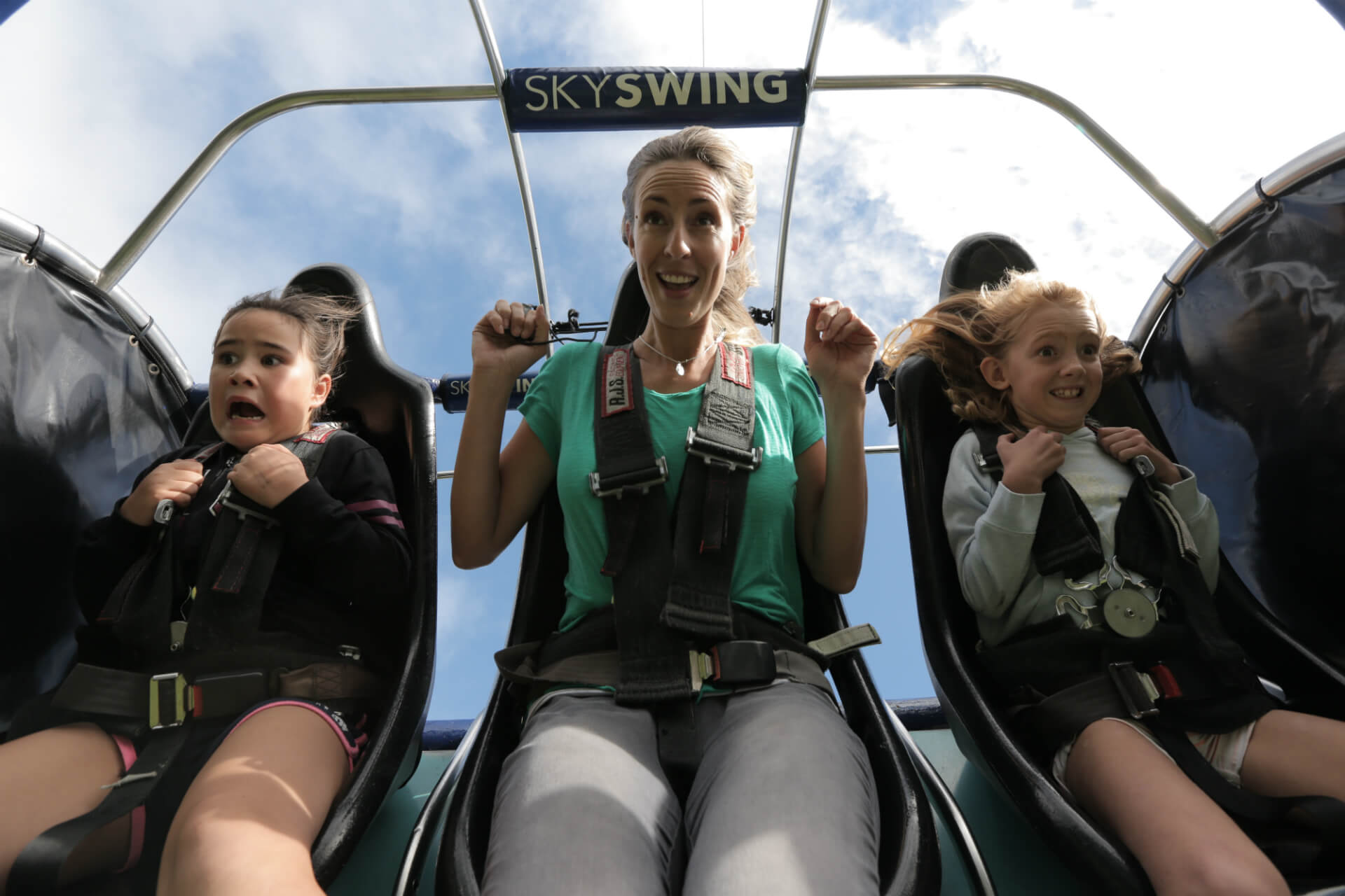 3 People About To Take Off On The Skyswing.