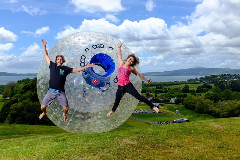 A couple jump to celebrate the Rotorua Zorb!