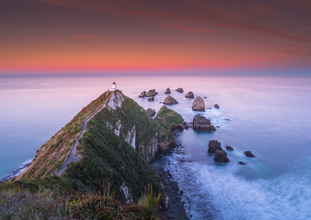 A sunset at the Nugget Point Lighthouse located in Clutha, New Zealand.