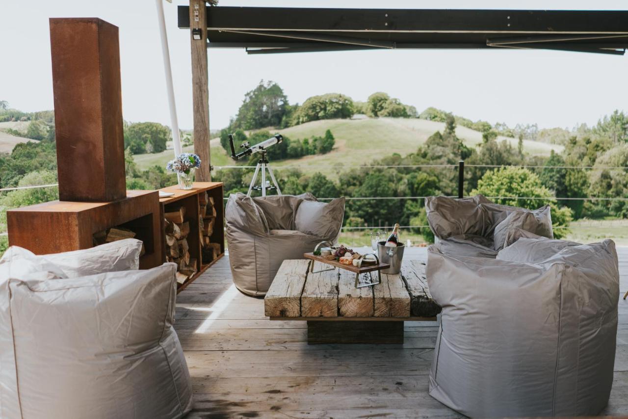Bean bags surround a low coffee table next to and outdoor fire at Oakridge Glamping in Rotorua.
