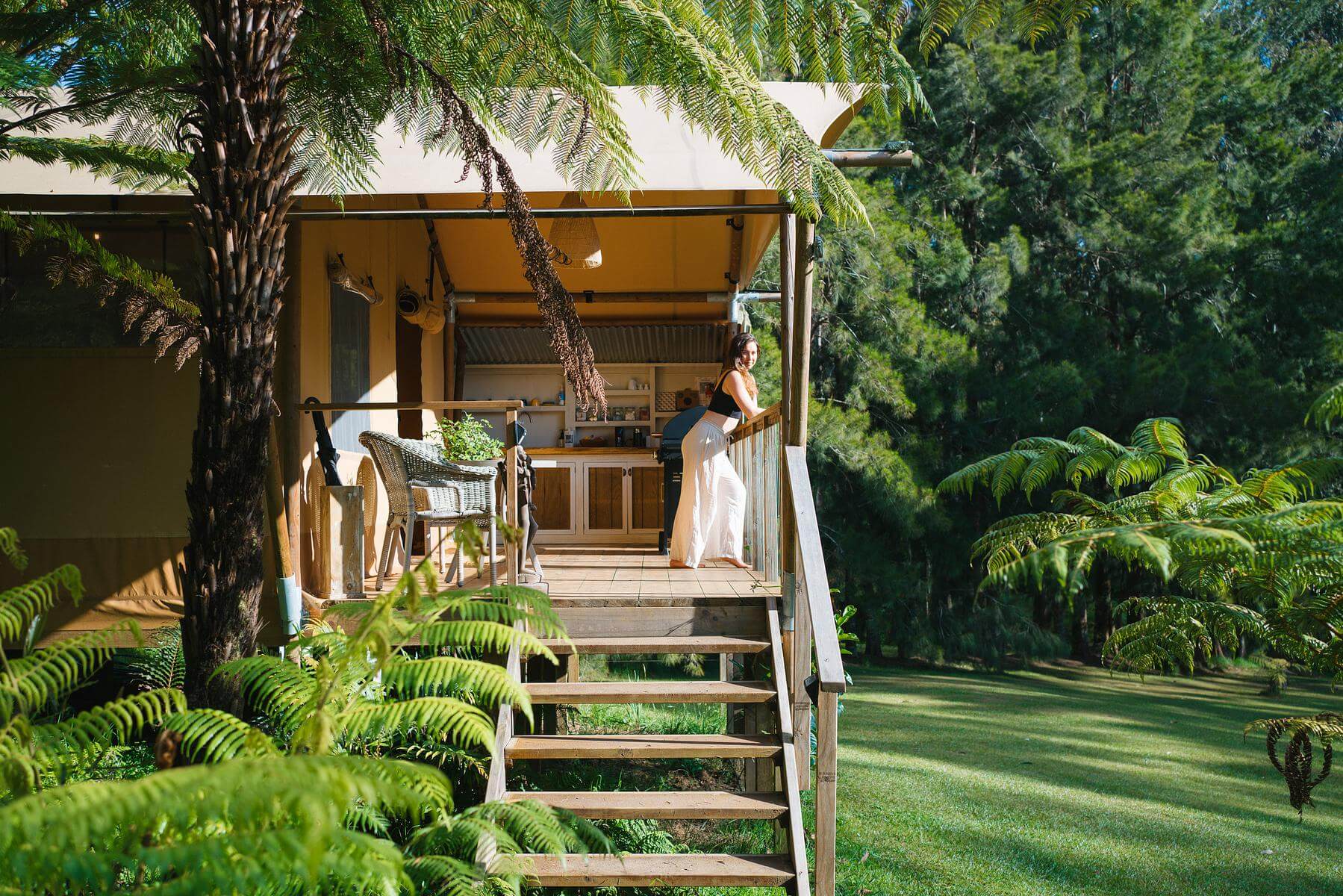 A woman hangs out on the second story balcony of the Rhino’s Retreat in Northland.