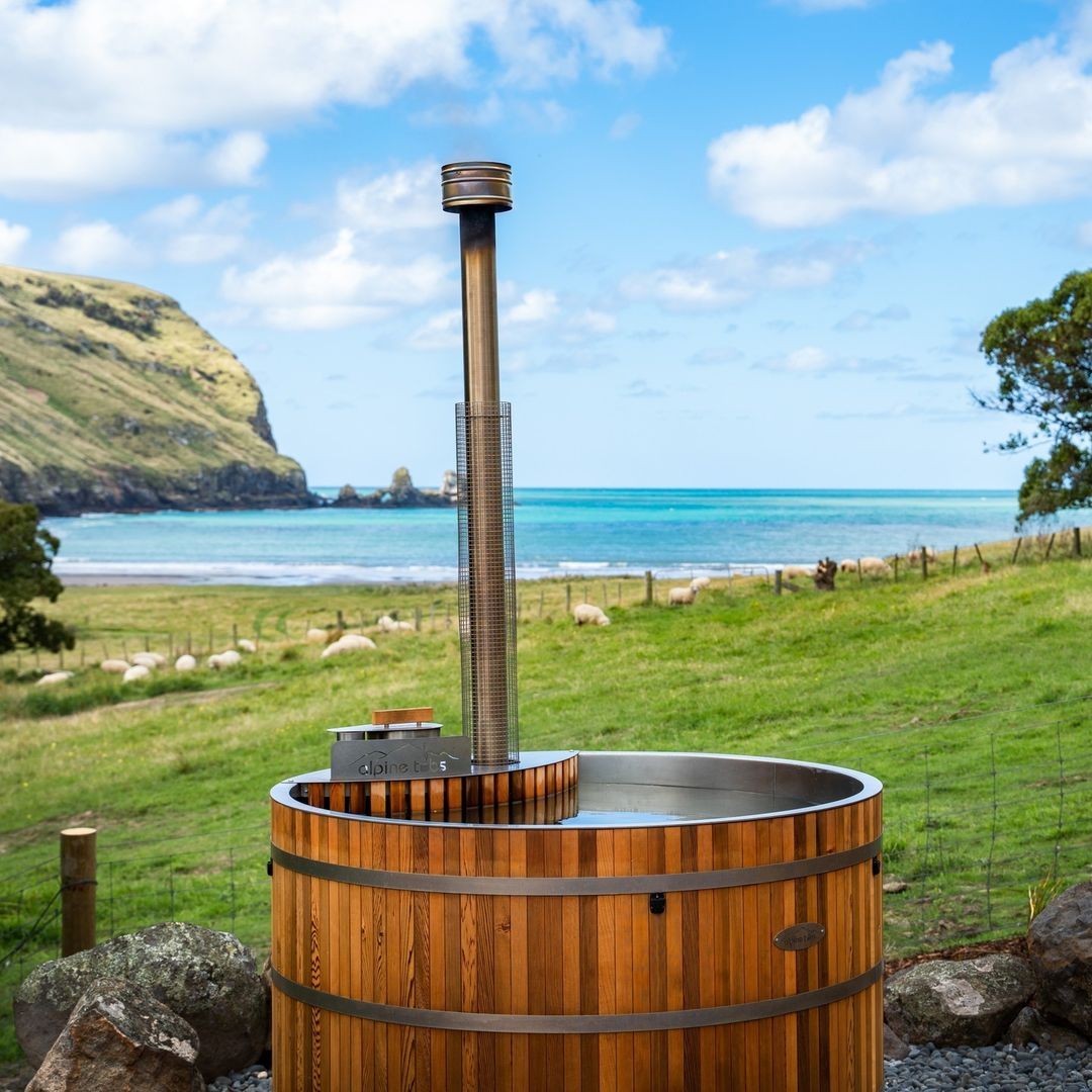 The spectacular coastal and farm viewpoint from the Lavericks Bay cedar hot tub.