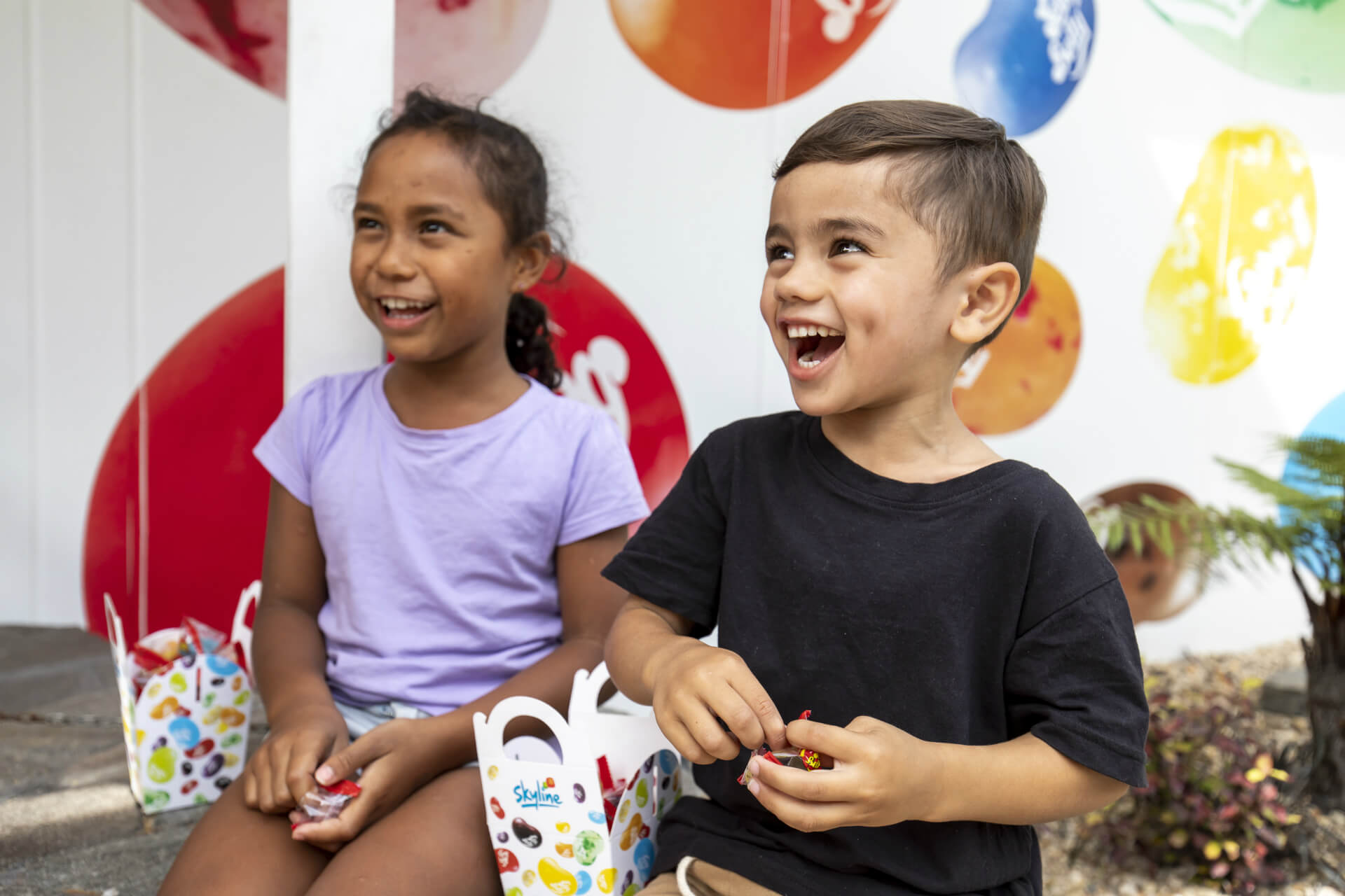 Two Kids Laughing And Eating Their Jelly Beans.