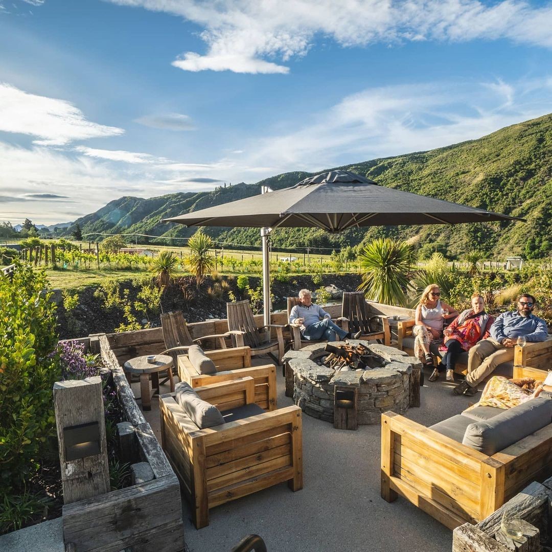 Friends hanging out and enjoying wine and nibbles at the Gibbston Valley Winery.