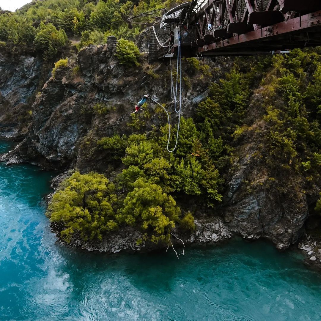 A man and woman jump tandem from the Kawarau Bungy Bridge in Queenstown.