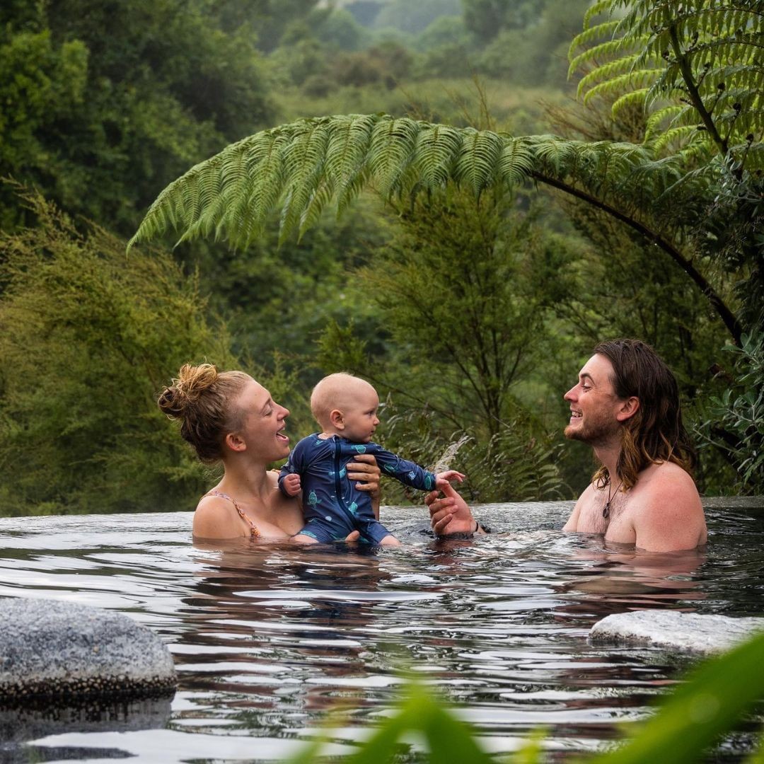 A family enjoys a thermal hot pool at Waikite Valley Hot pools.