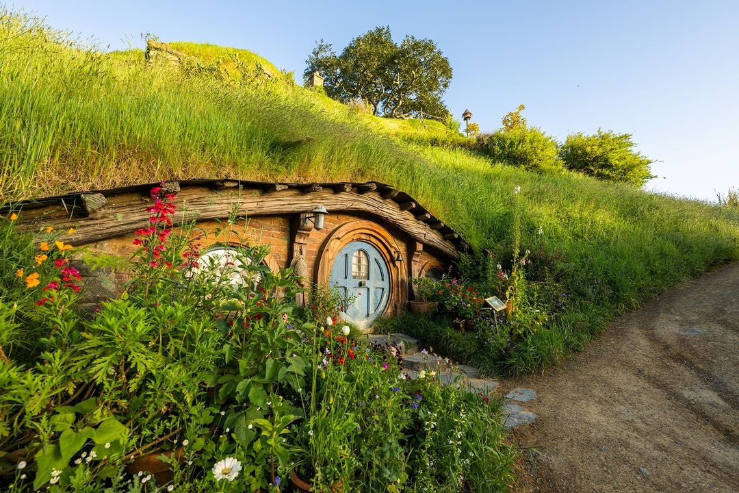 A Hobbit Hole tucked into the hillsides at the official Hobbiton movie set in Matamata, New Zealand.