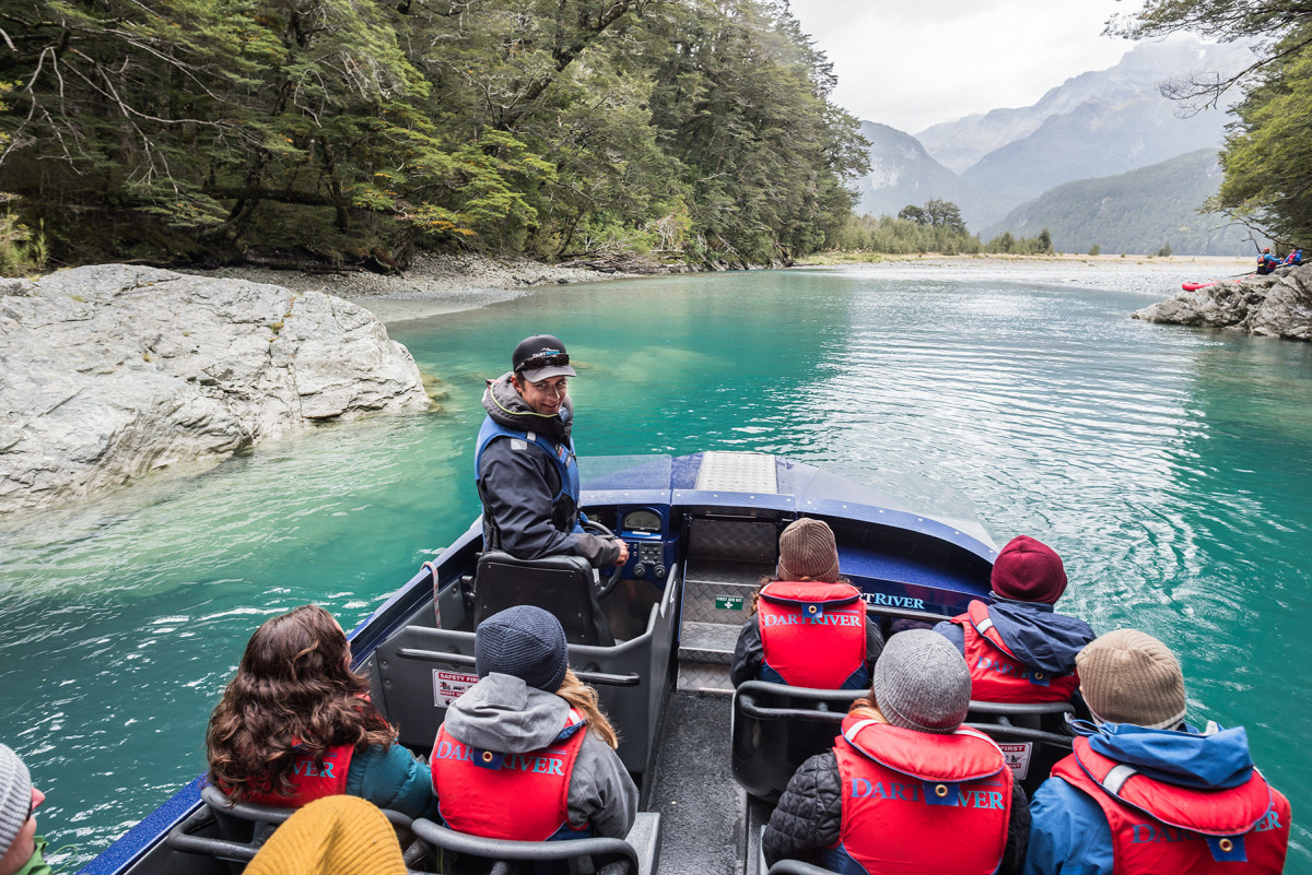 A Dart River Jet driver stops the boat and talks to customers on a Wilderness Jet Experience in Queenstown.