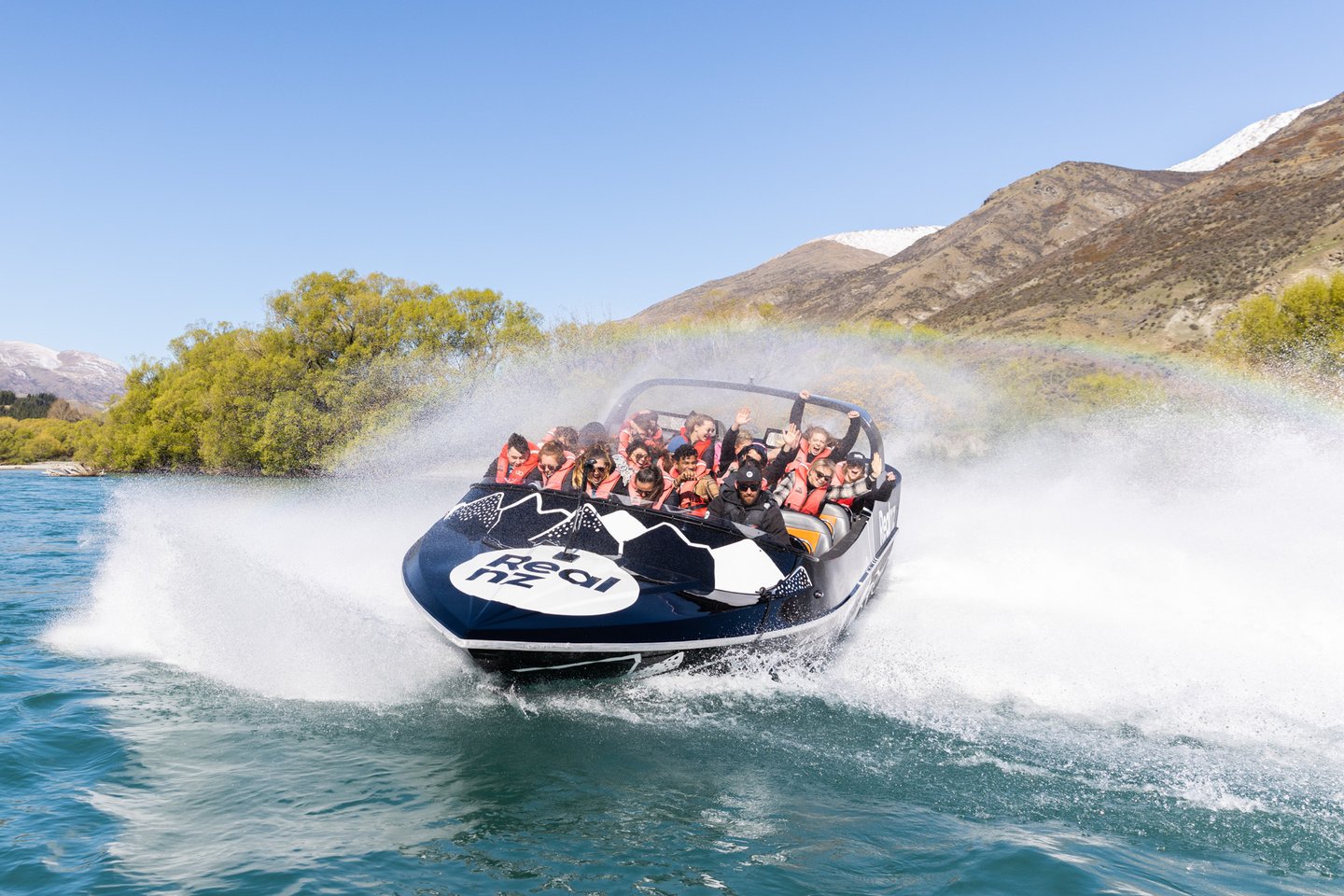 A Real NZ Jet does a 360-degree spin with a boat full of screaming customers in Queenstown.