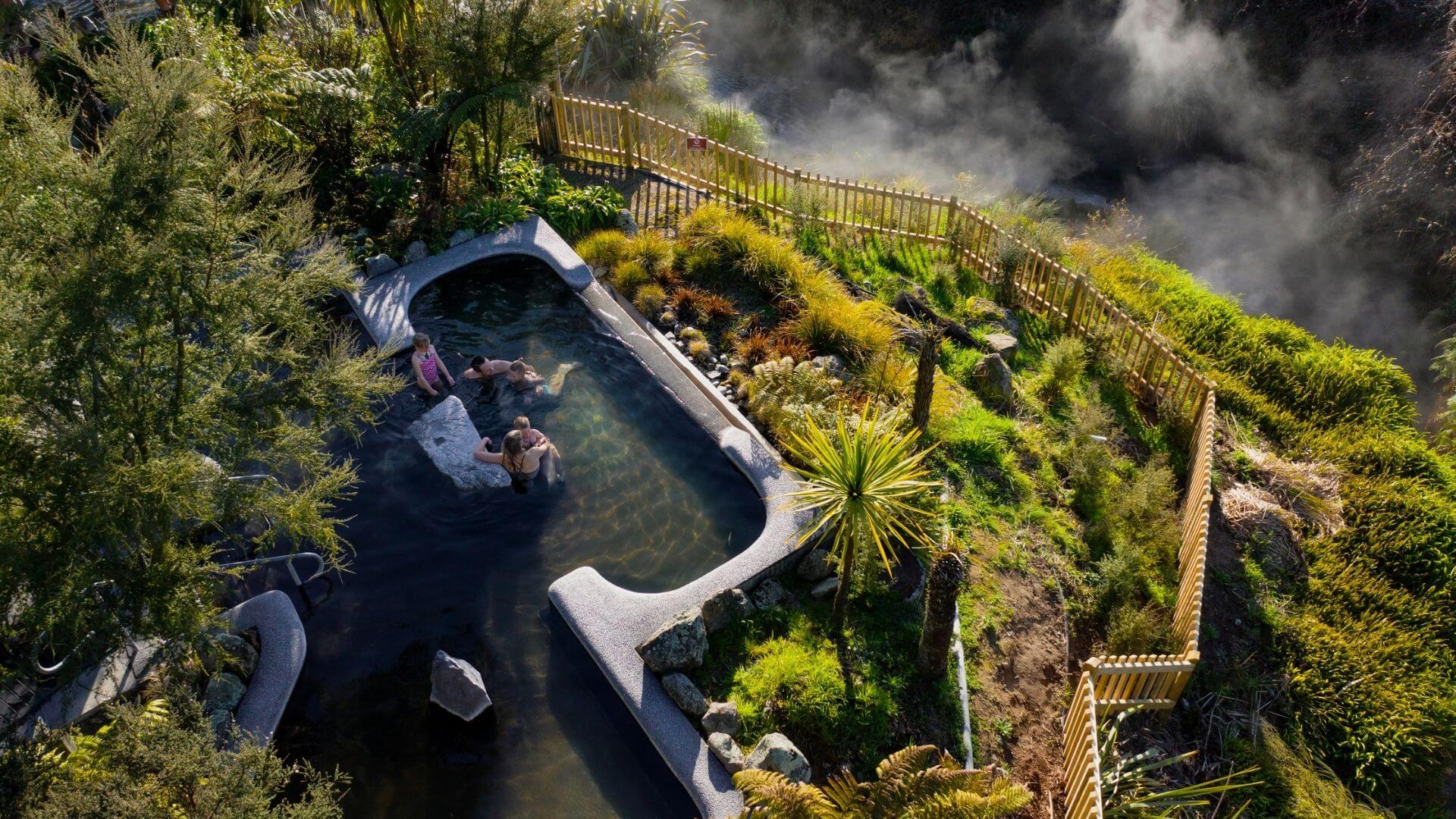 An aerial photo of people enjoying the Waikite Valley Thermal Pools in Rotorua.