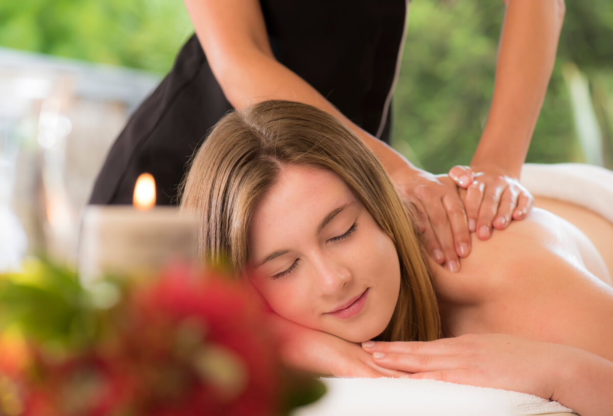 A women relaxes as she gets a deep tissue massage at Wai Ora Lakeside Spa Resort