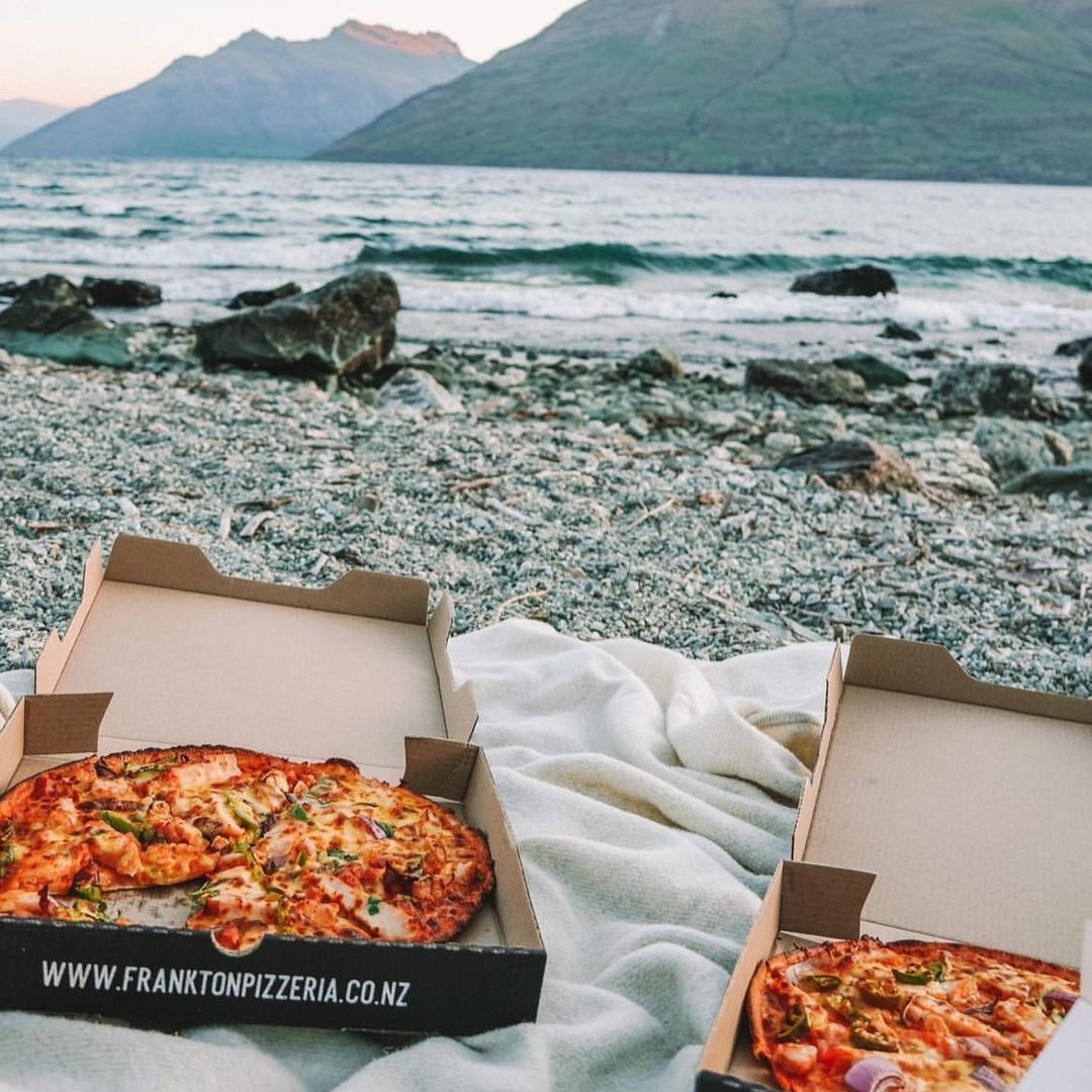 Two pizzas from Frankton Pizzeria ready to be eaten at the lakeside in Queenstown.