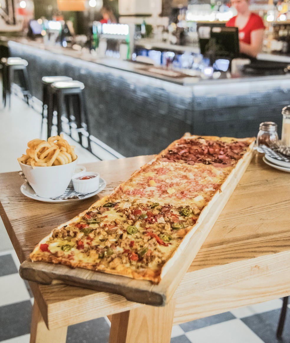 A three foot pizza and curly fries at the London Underground Queenstown.