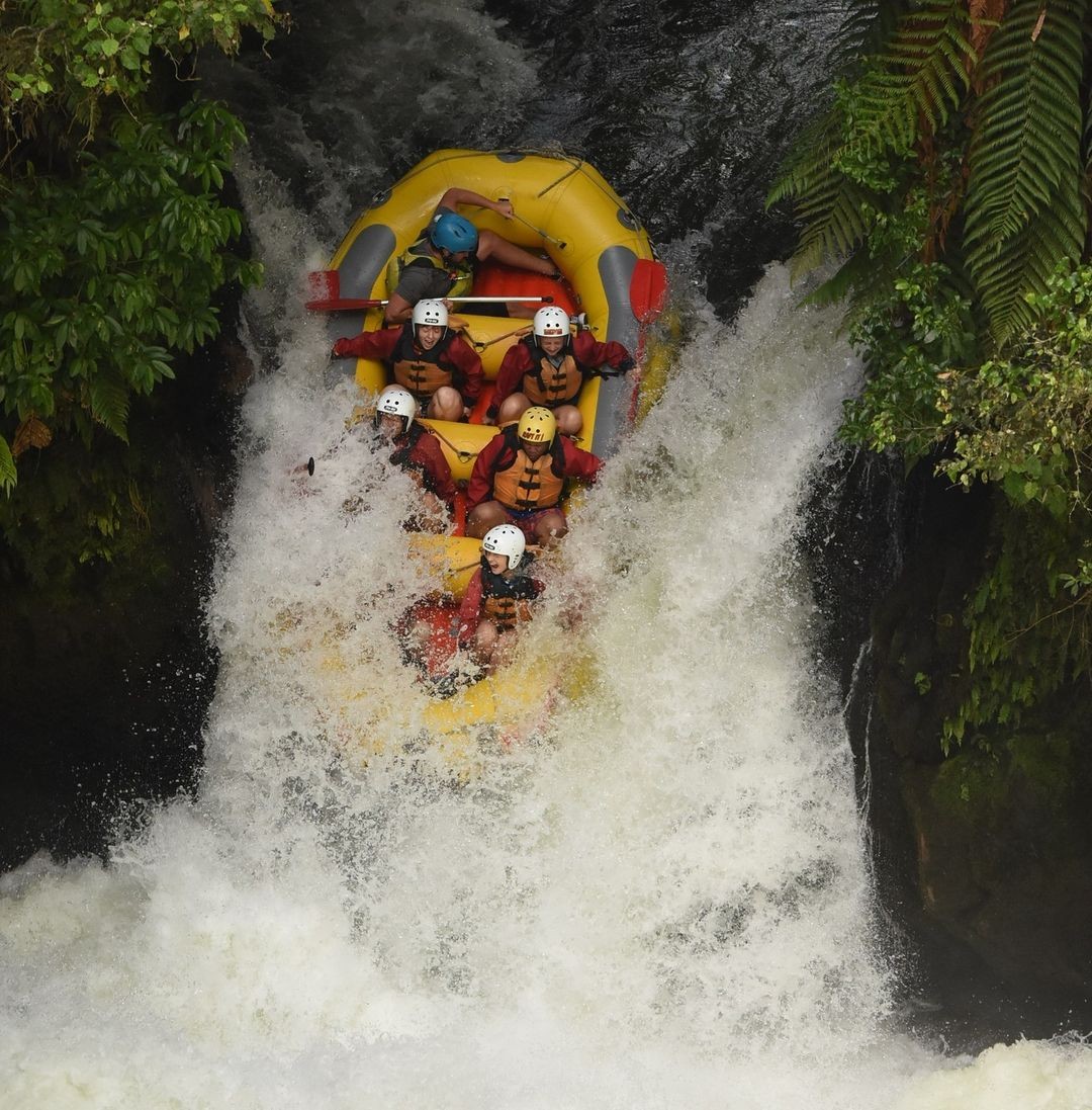 A group of customers descend the impressive 7m high Tutea falls on a Kaitiaki Adventures rafting trip.