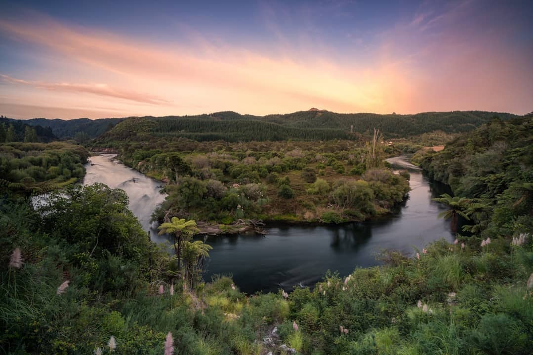 A photo of a horseshoe bend in the Rangitaiki River at sunset.