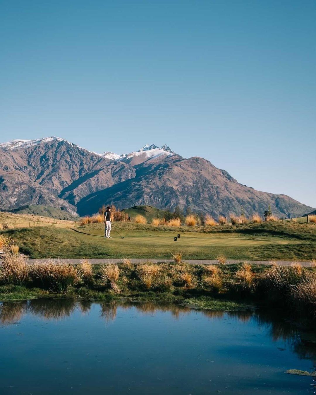 A man putts on a golf green at the Arrowtown Golf Course in Queenstown.