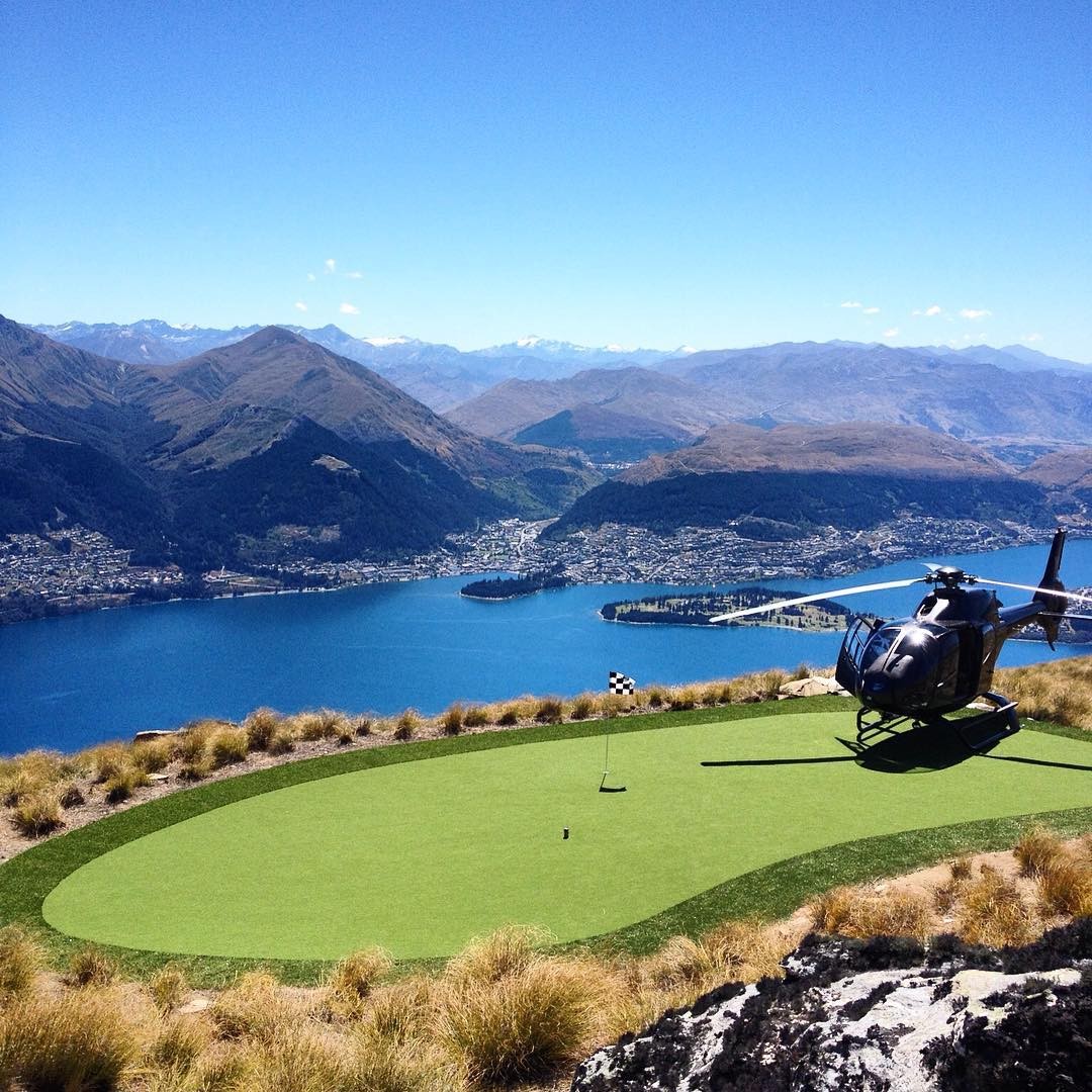 A helicopter lands on the golf green atop Cecil Peak in Queenstown.