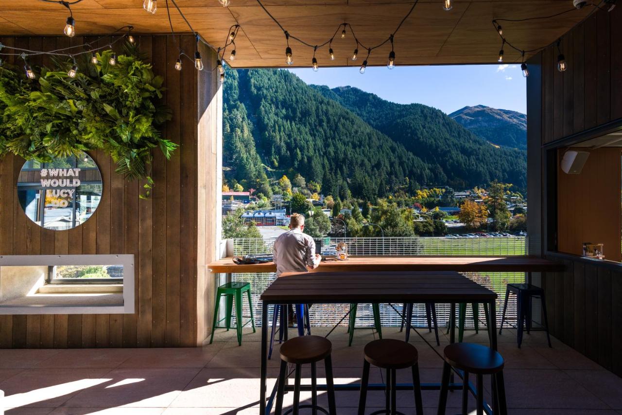 A man enjoys a drink and a beer at the Jucy Snooze bar and pizzeria in Queenstown.