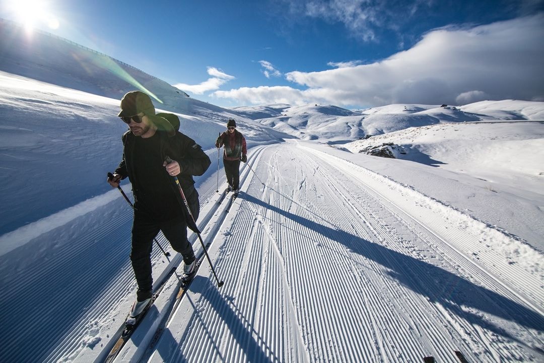 Two cross-country skiers enjoy pristine snow conditions at Snow Farm Wanaka.
