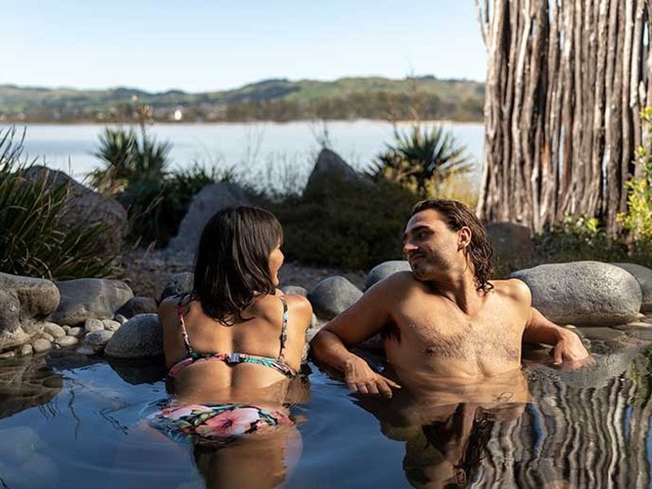 A couple enjoys the therapeutic waters of Polynesian Spa in Rotorua New Zealand.