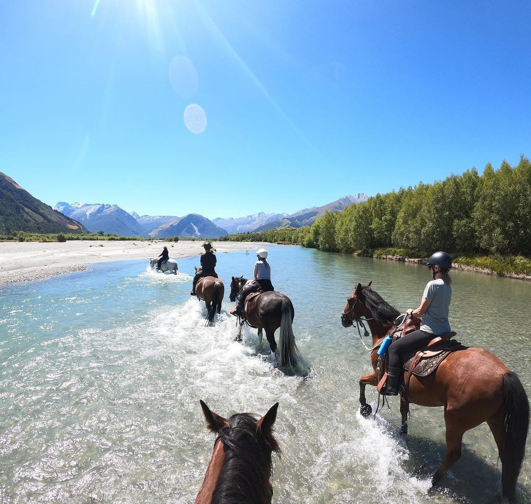 A group of friends go on a guided horse trek through rivers and mountain passes.