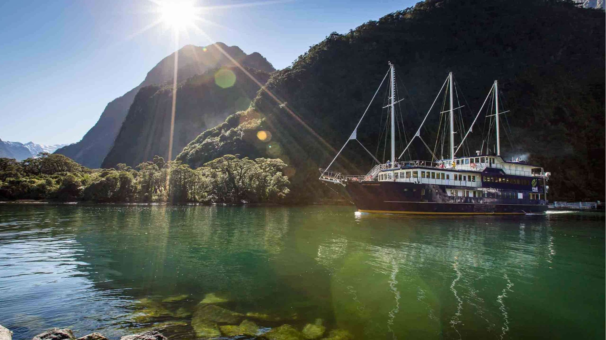 Stunning Milford Sound picture with overnight boat departing on a tour.