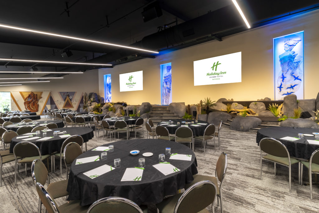 A meeting setup with circle tables in the Pohutu conference and events centre at the Holiday Inn Rotorua.