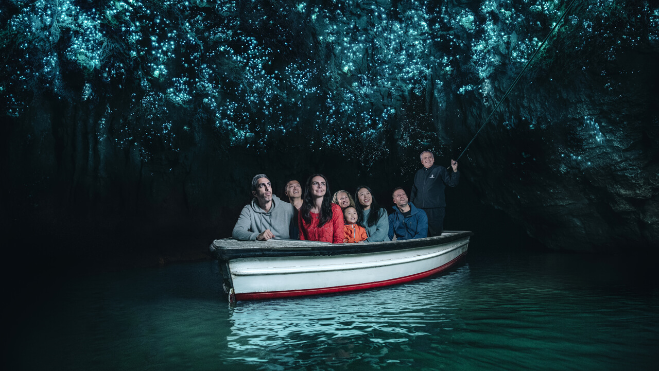 A group of customers enjoy a Waitomo Cave tour in Rotorua, New Zealand.