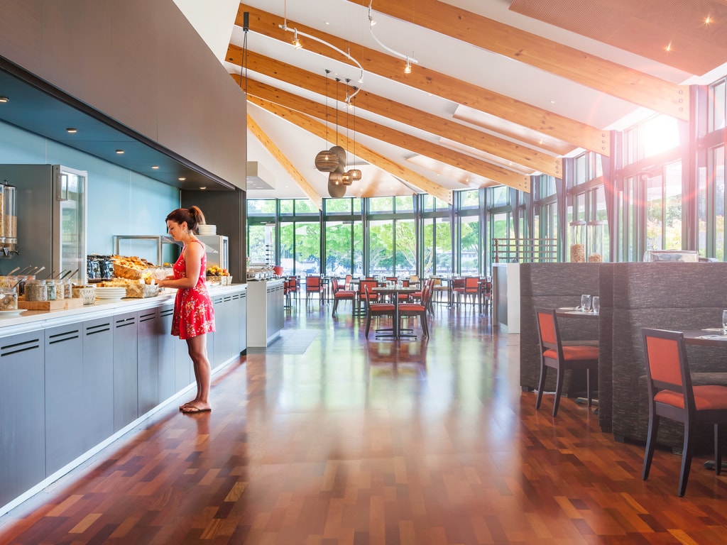 A woman serves herself of delectable treats from the Atlas Restaurant buffet.