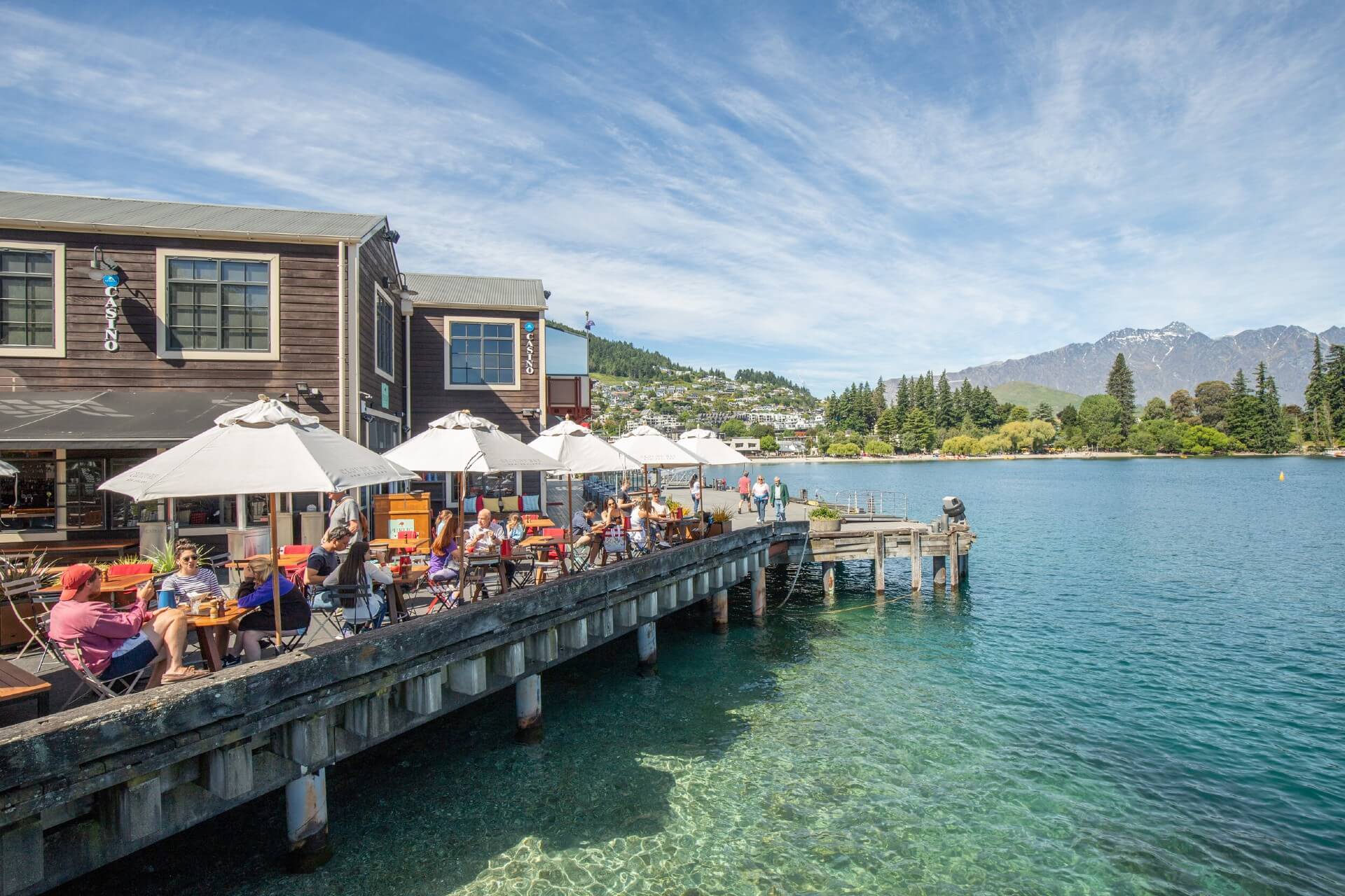 Diners revel in the Public Kitchen's on wharf setting with the tranquil waters of Lake Wakatipu lapping beneath them.