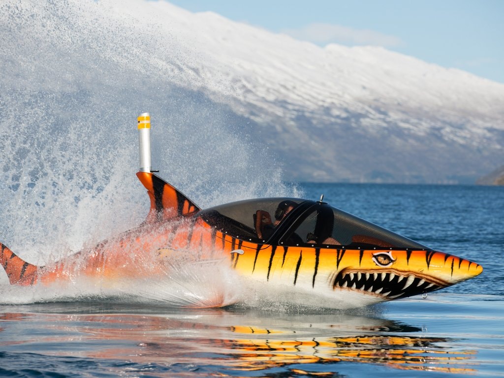 A Hydro Attack shark shaped watercraft cuts through the waters of lake Wakatipu in Queenstown.