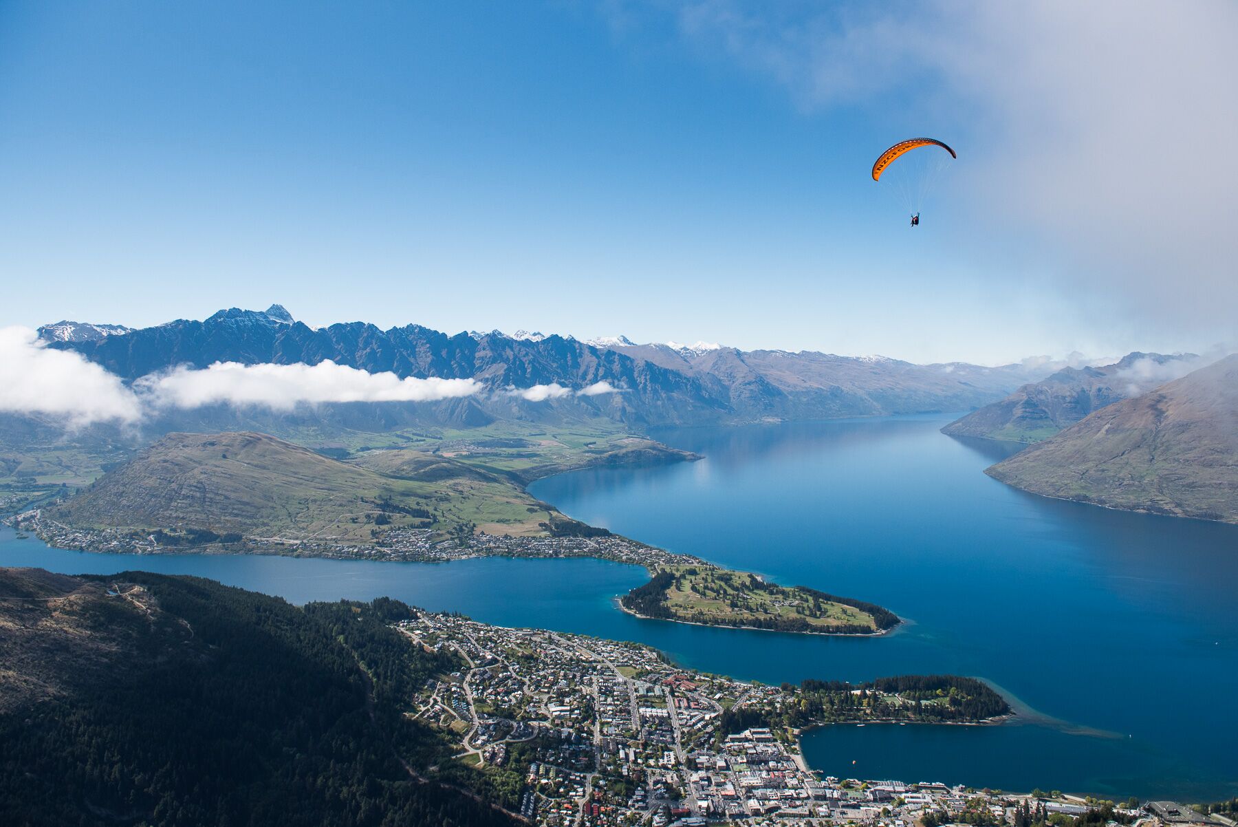 A paraglider soars high above Queenstown allowing the customer to soak up the incredible panorama.
