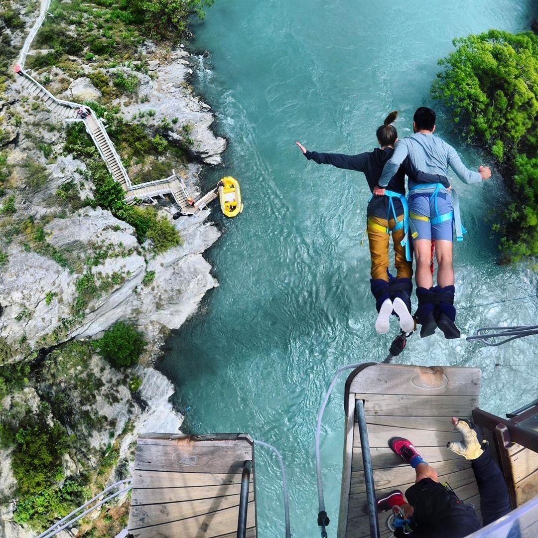 A couple jumps of the Kawarau Bungy Bridge together in Queenstown new Zealand.
