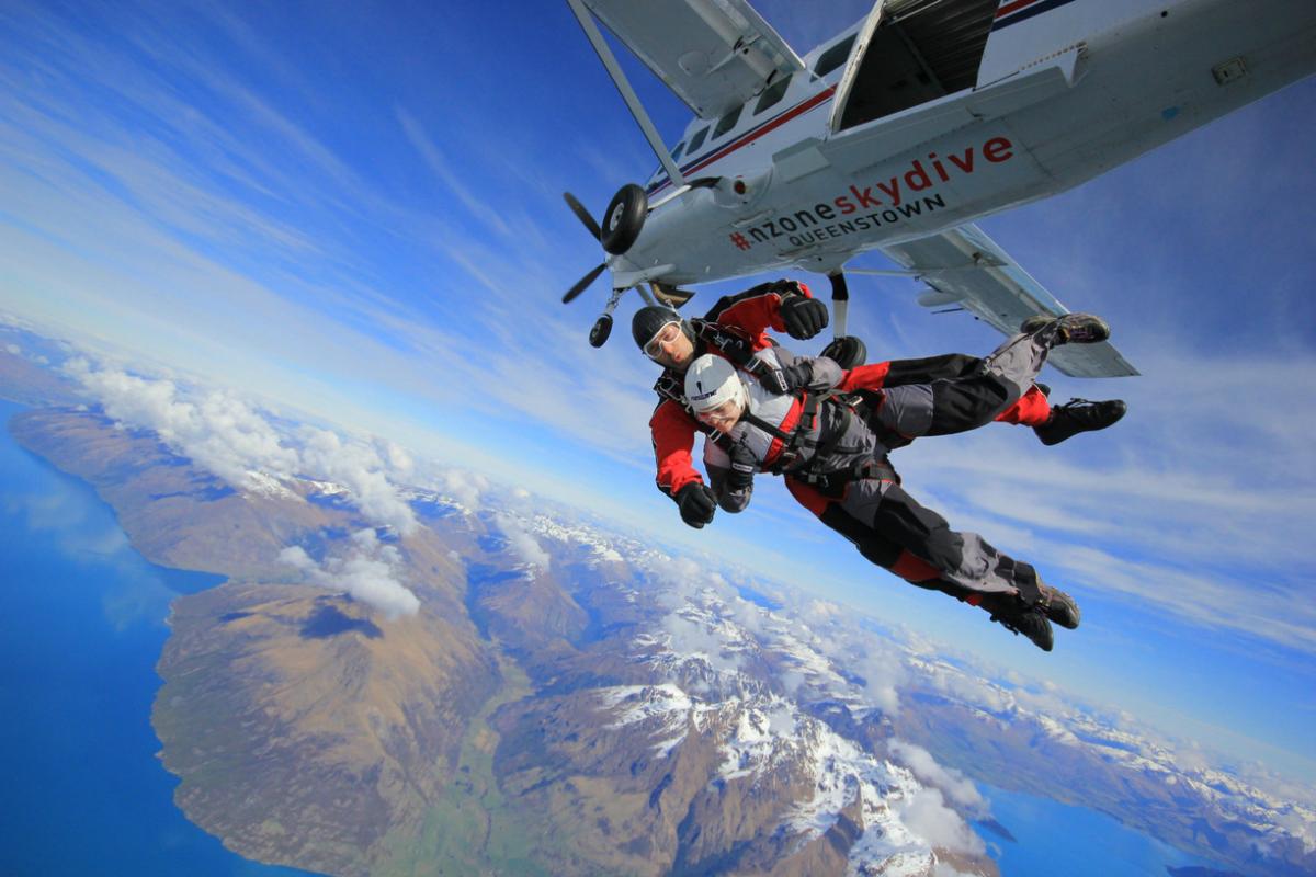 A person goes skydiving high above Queenstown with local company NZONE.