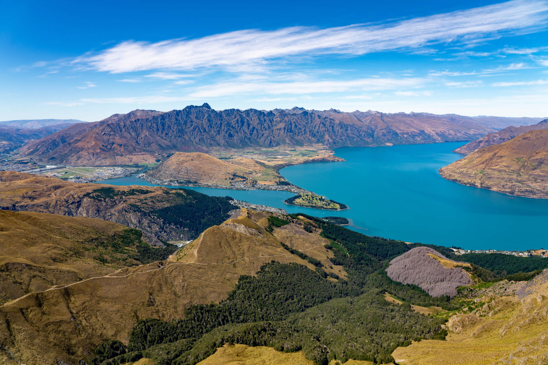 Panoramic photo of The Remarkables, Lake Wakatipu and Queenstown from the summit of Ben Lomond.
