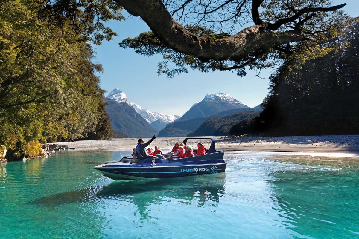 A group of customers enjoy a jet boating adventure on the Dart River.