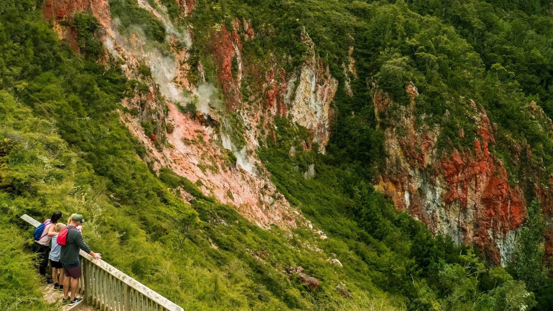 People stop to appreciate the views along the Rainbow Mountain track.