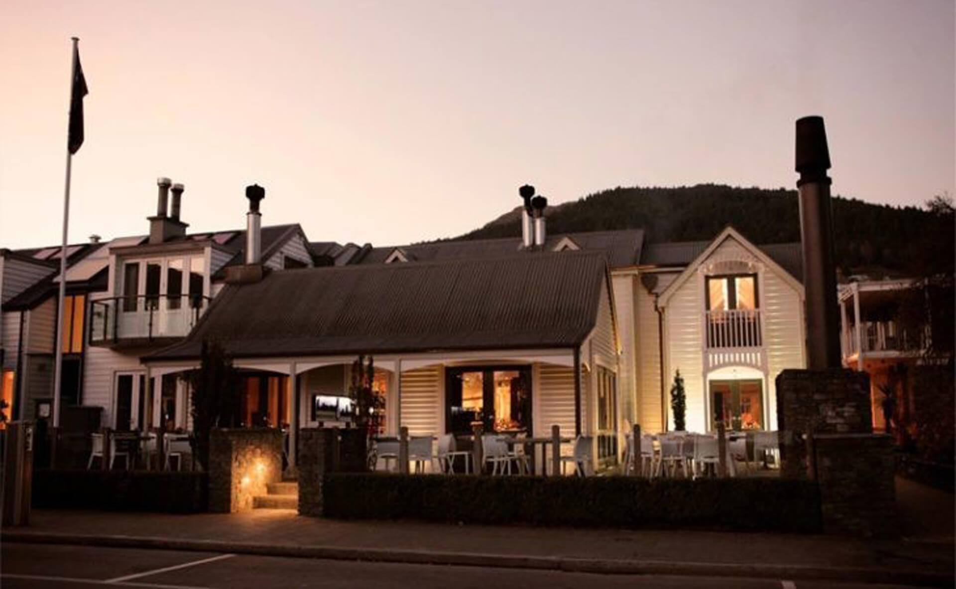 Botswana Butchery sits lit up by lights at dusk.