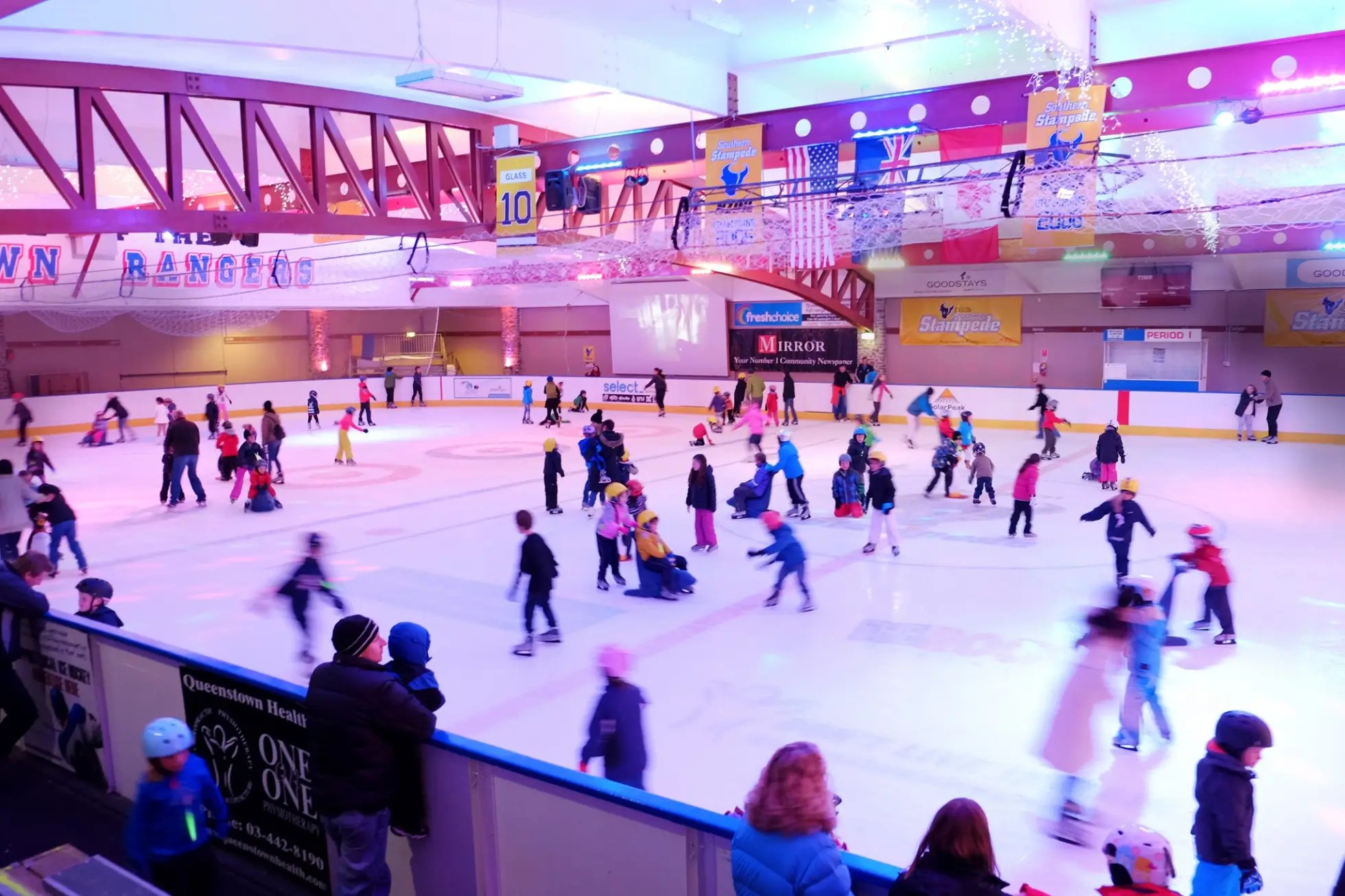 Queenstown Ice Arena rink filled with kids and families ice skating.