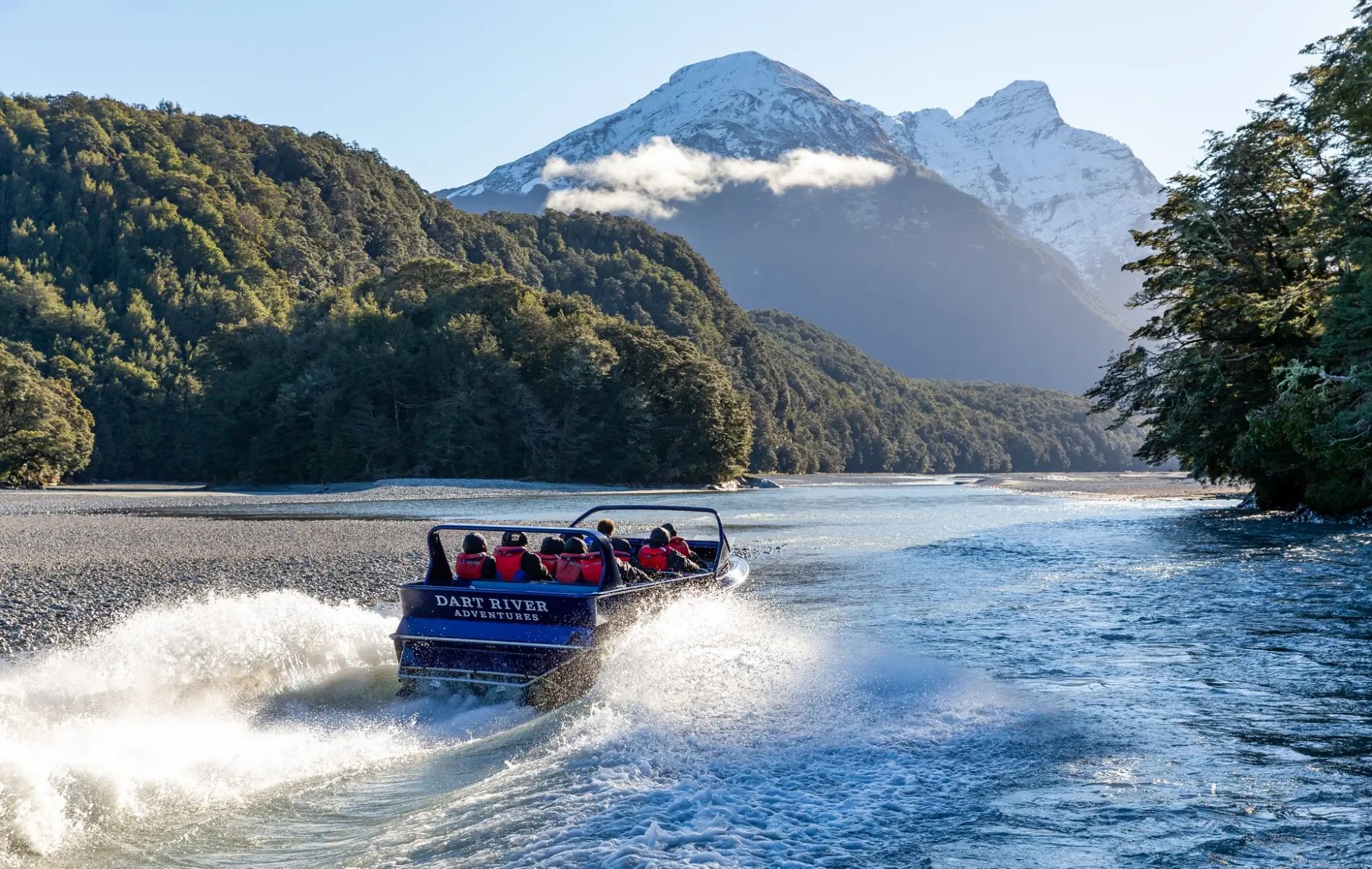 Jet boat rushing down the Dart River, Glenorchy, towards the mountains.
