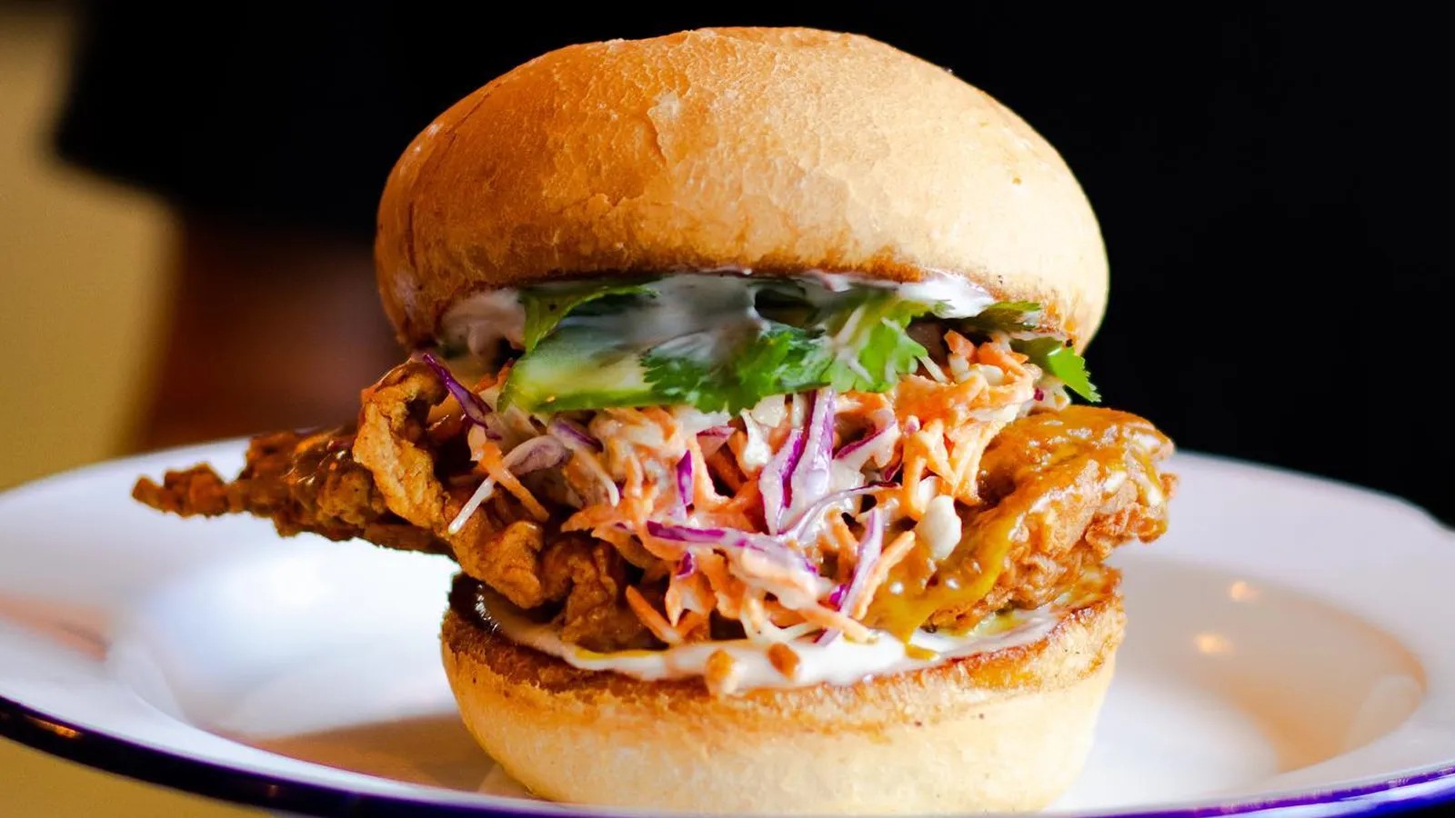 Satay chicken burger on a plate.