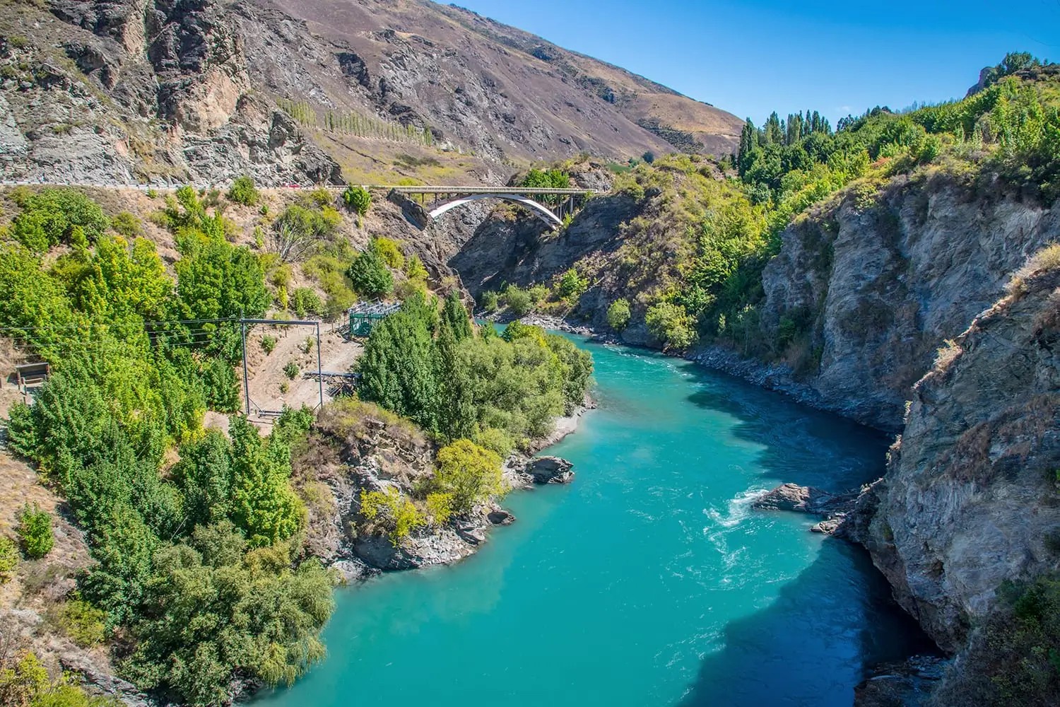 Kawarau River with historical suspension bridge in the distance.