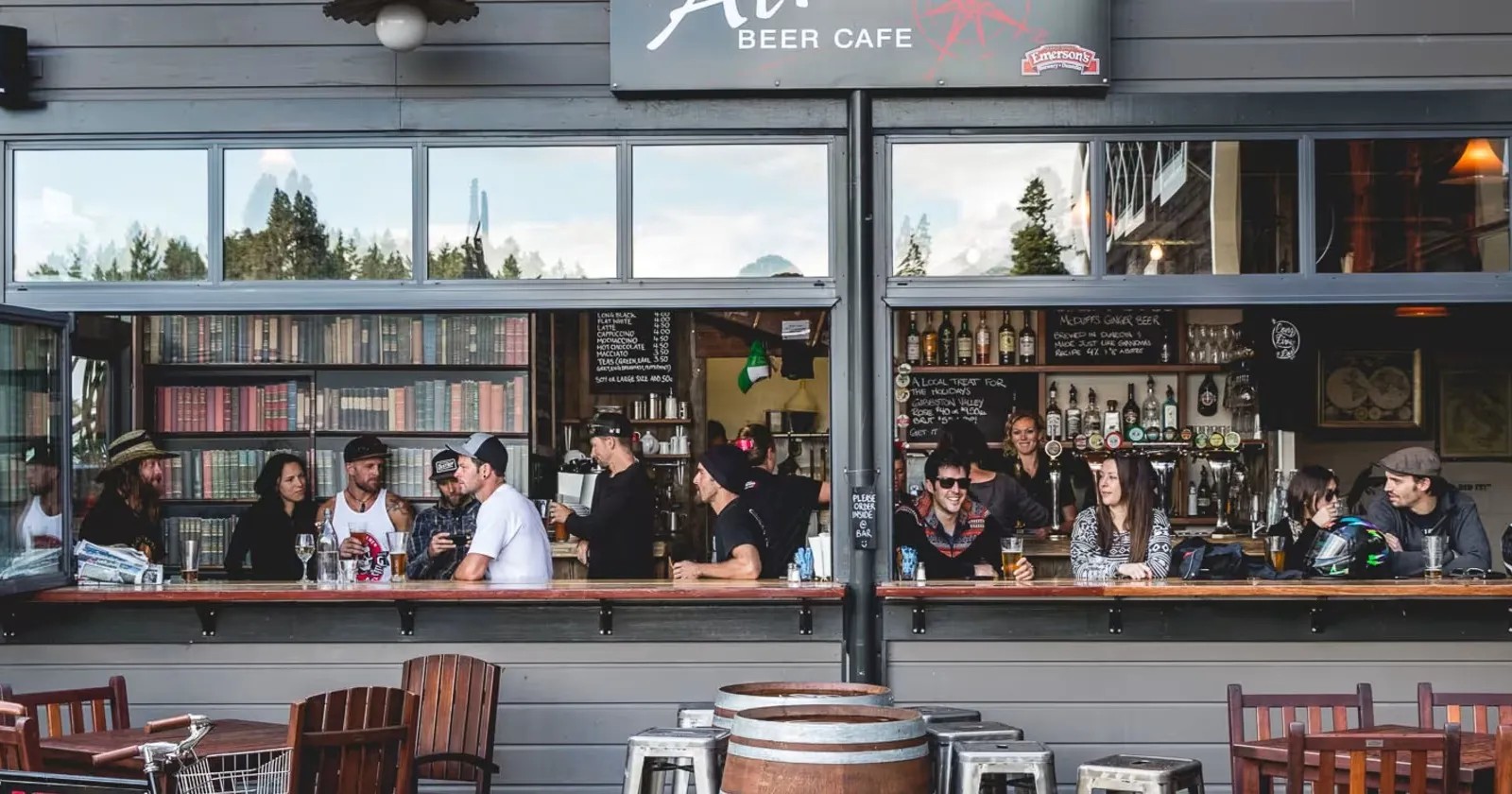 Many customers drinking beer in the outdoor sit-down area at Searchlight Brewery in Queenstown.