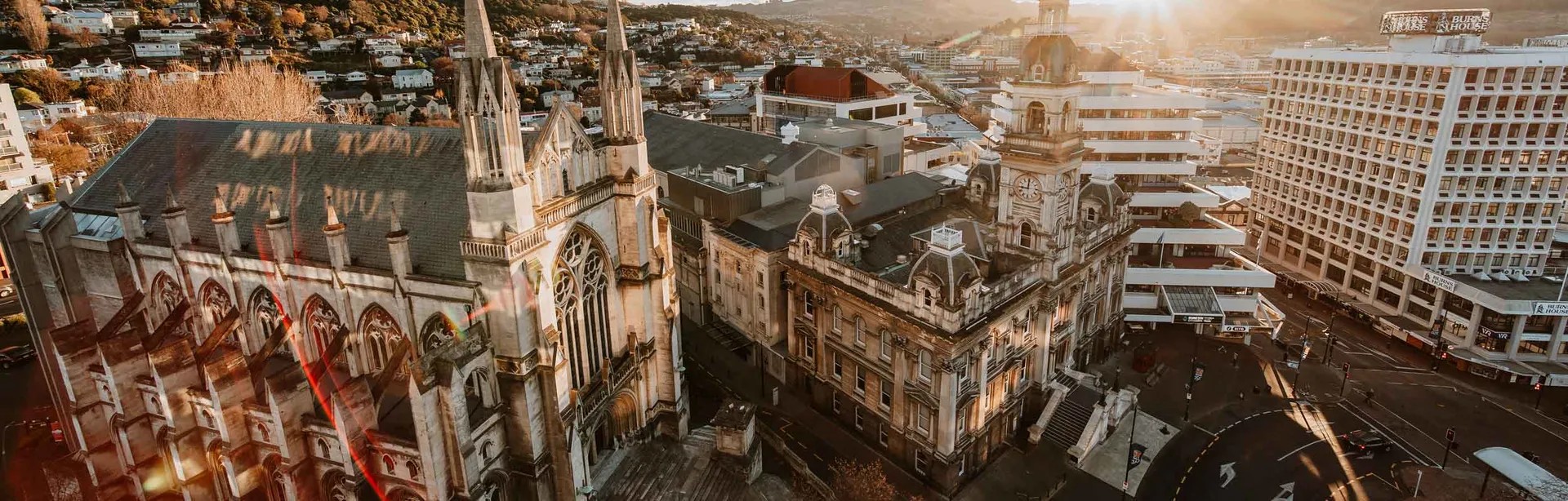 The exterior of Dunedin Cathedral, a historical Anglican church, from above at sunset.