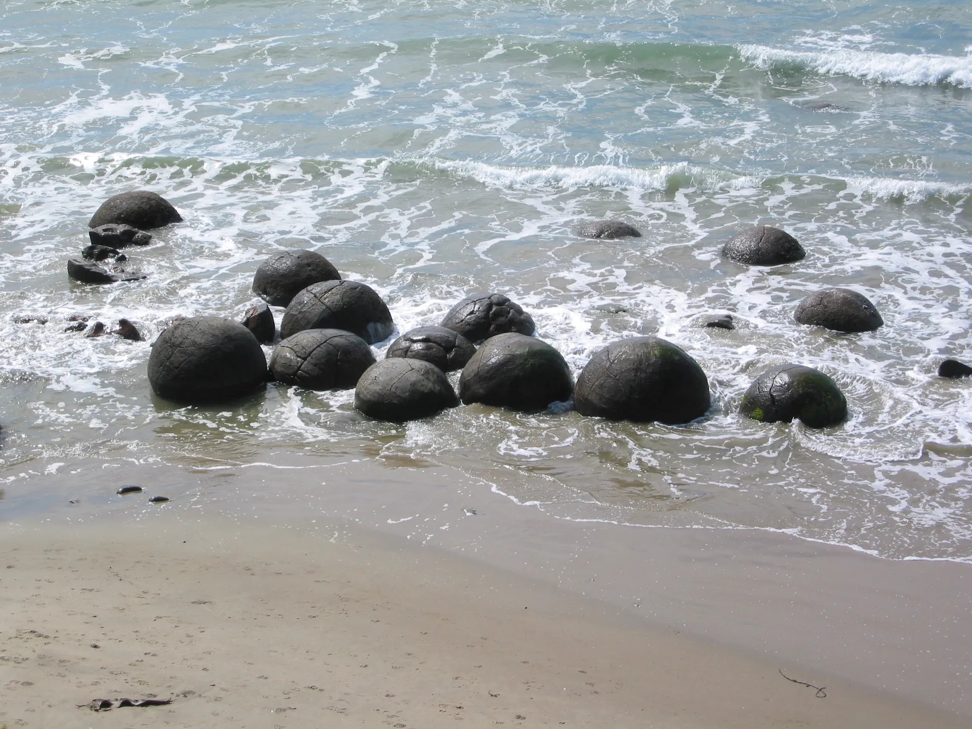 Cluster of large round boulders on the beach at Moeraki.